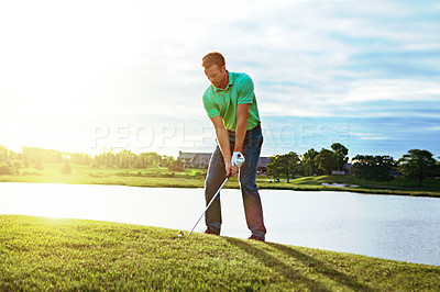 Buy stock photo Shot of a young man spending the day on a golf course