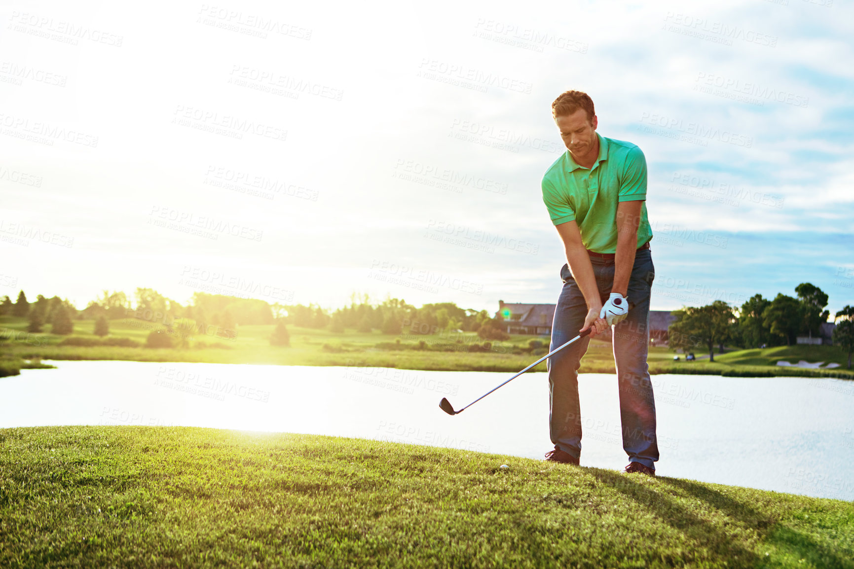 Buy stock photo Shot of a young man spending the day on a golf course