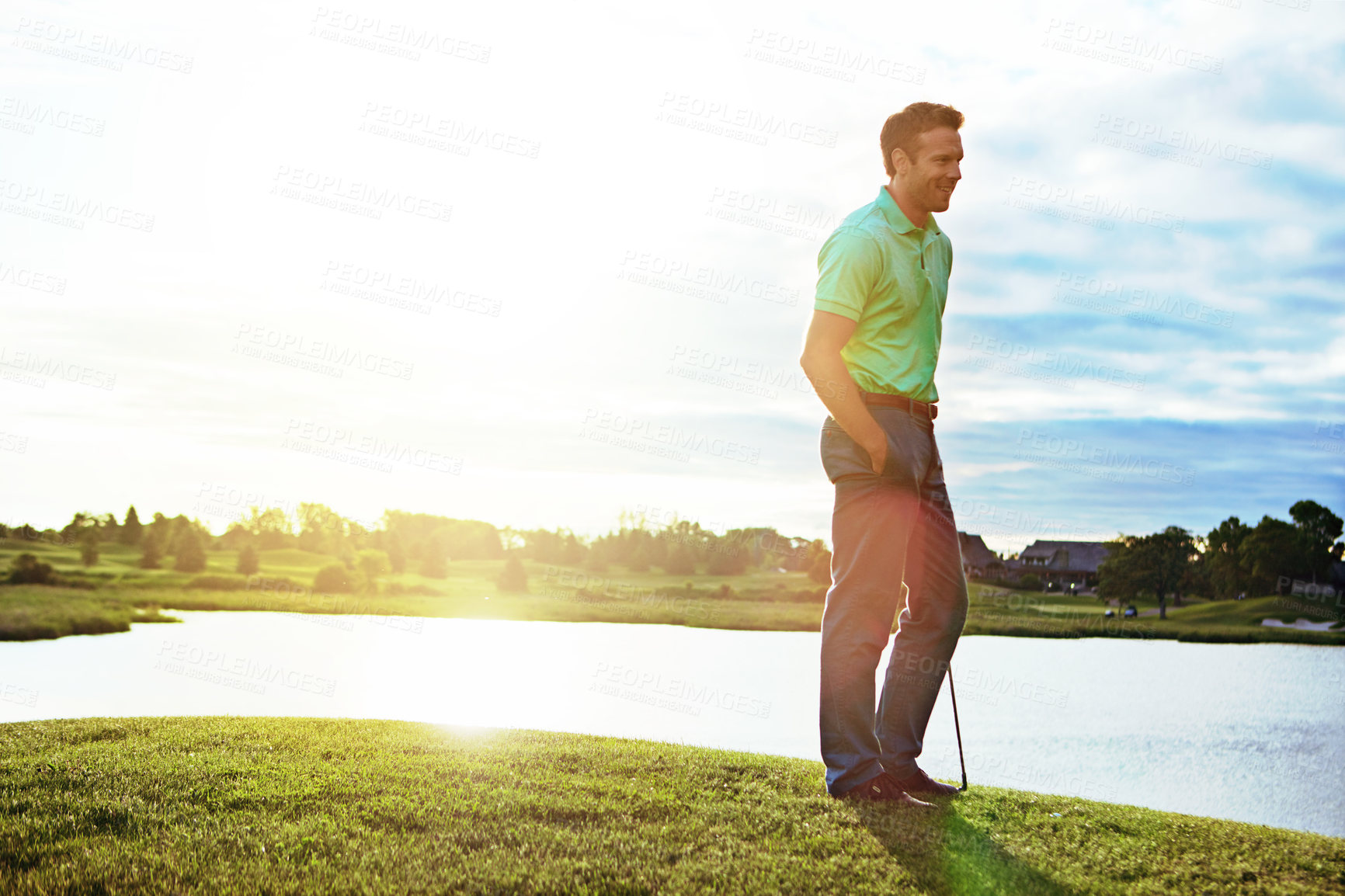 Buy stock photo Shot of a young man spending the day on a golf course