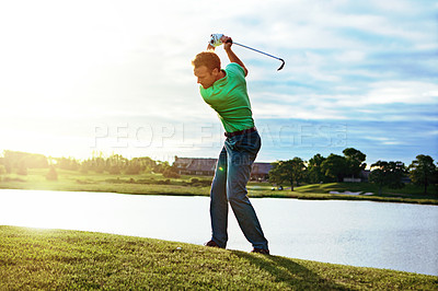 Buy stock photo Shot of a man practicing his swing on the golf course