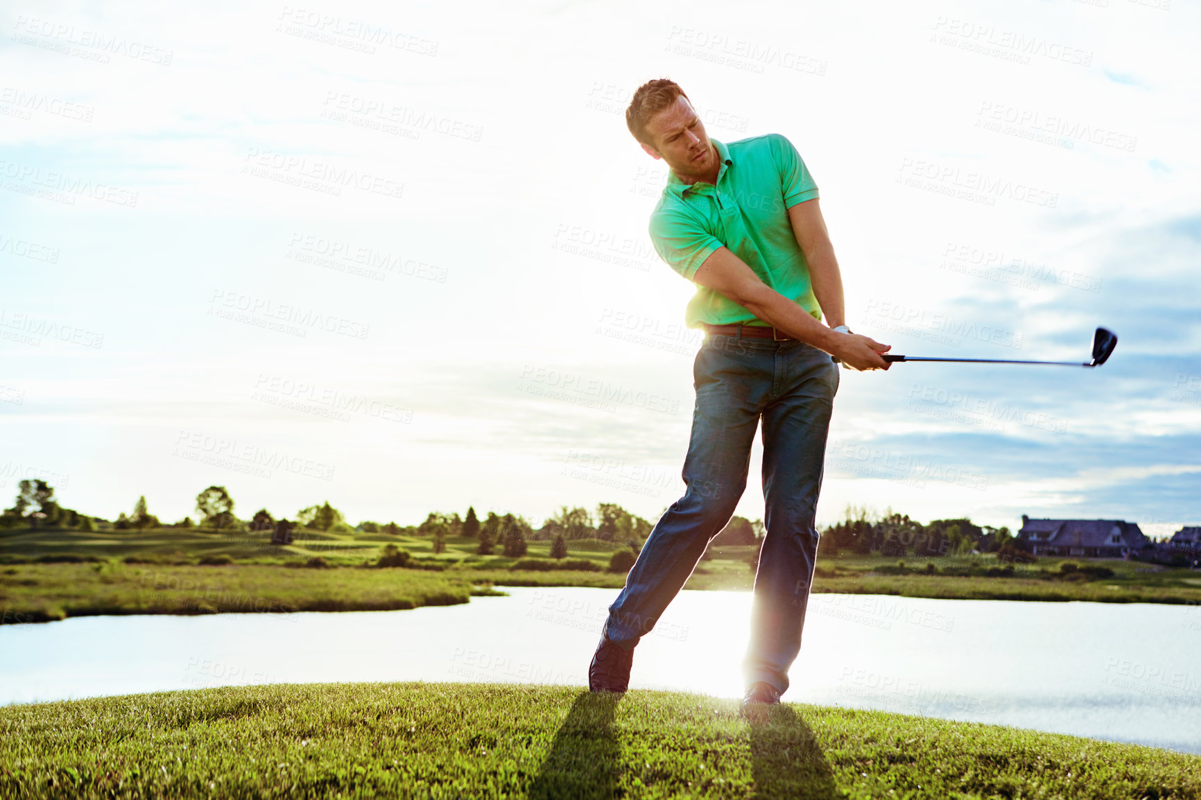 Buy stock photo Shot of a man practicing his swing on the golf course