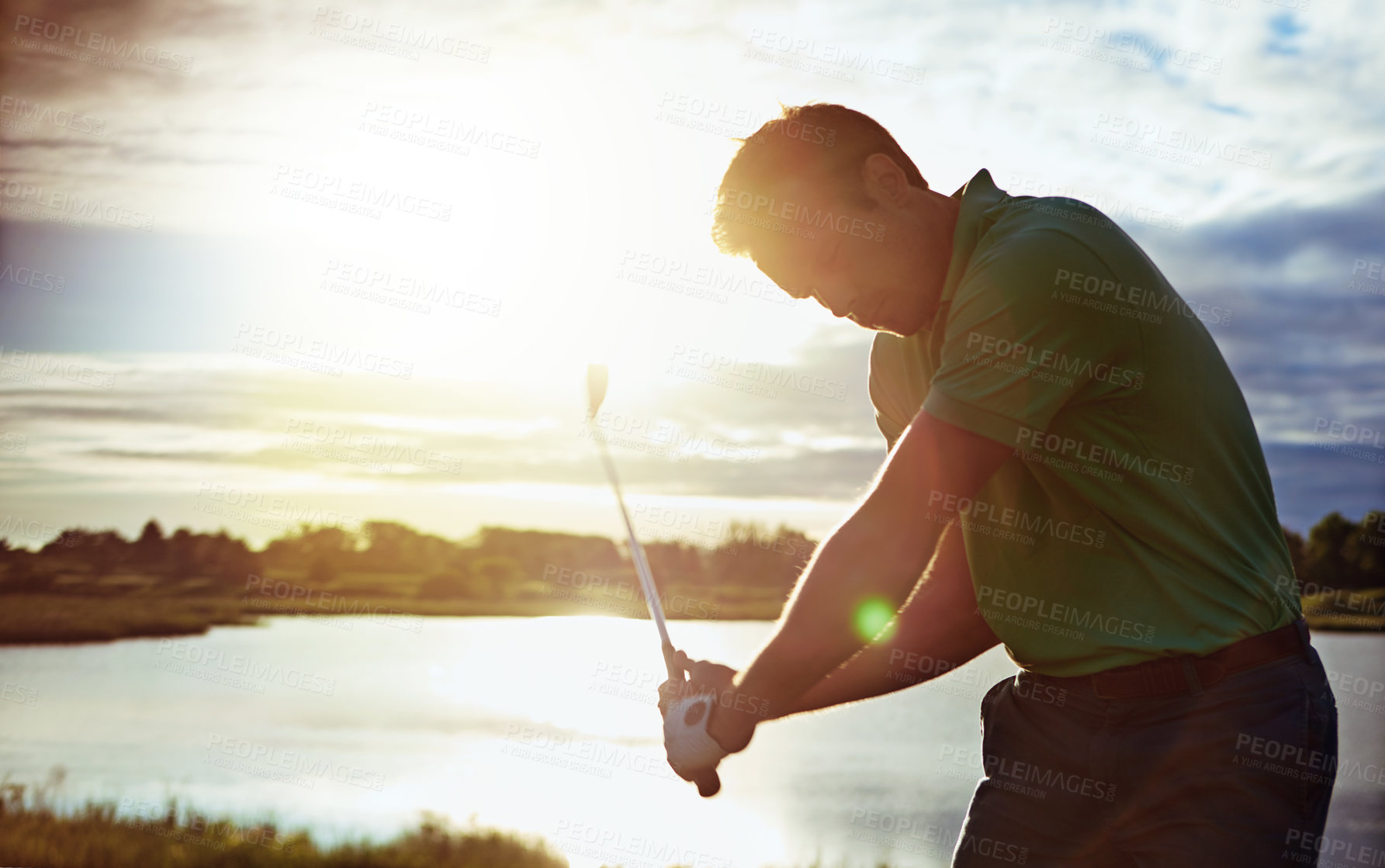 Buy stock photo Shot of a man practicing his swing on the golf course