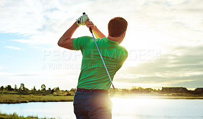 Buy stock photo Shot of a man practicing his swing on the golf course