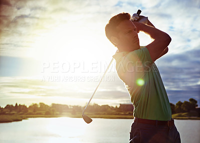 Buy stock photo Shot of a man practicing his swing on the golf course