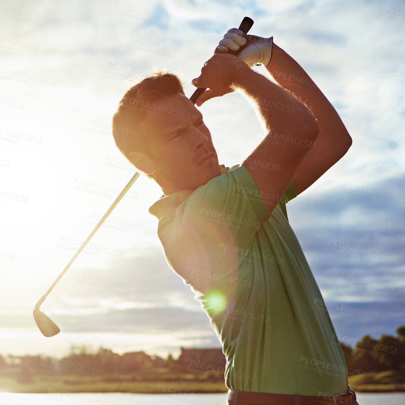 Buy stock photo Shot of a man practicing his swing on the golf course