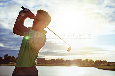 Buy stock photo Shot of a man practicing his swing on the golf course