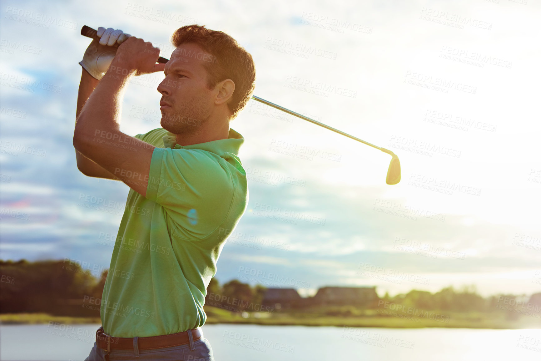 Buy stock photo Shot of a man practicing his swing on the golf course