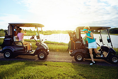 Buy stock photo Shot of friends riding in a golf cart on a golf course