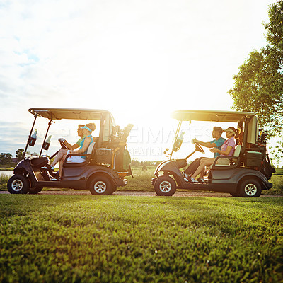 Buy stock photo Shot of a group of friends riding in a golf cart on a golf course