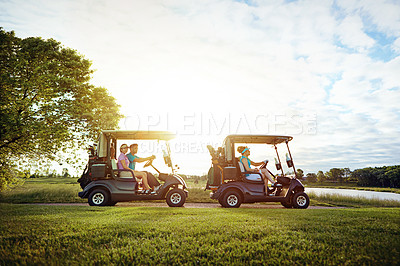 Buy stock photo Shot of a group of friends riding in a golf cart on a golf course