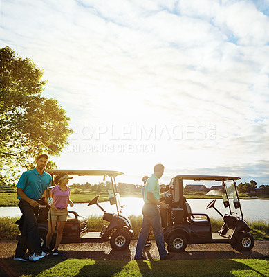 Buy stock photo Shot of a group of friends playing a round of golf on a fairway