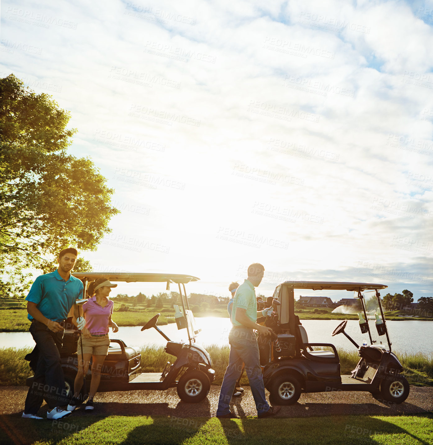 Buy stock photo Shot of a group of friends playing a round of golf on a fairway