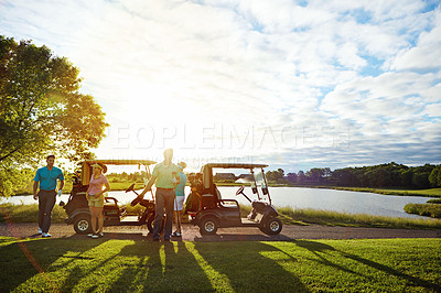 Buy stock photo Shot of a man playing a round of golf with his friends