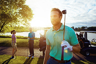 Buy stock photo Shot of a man playing a round of golf with his friends