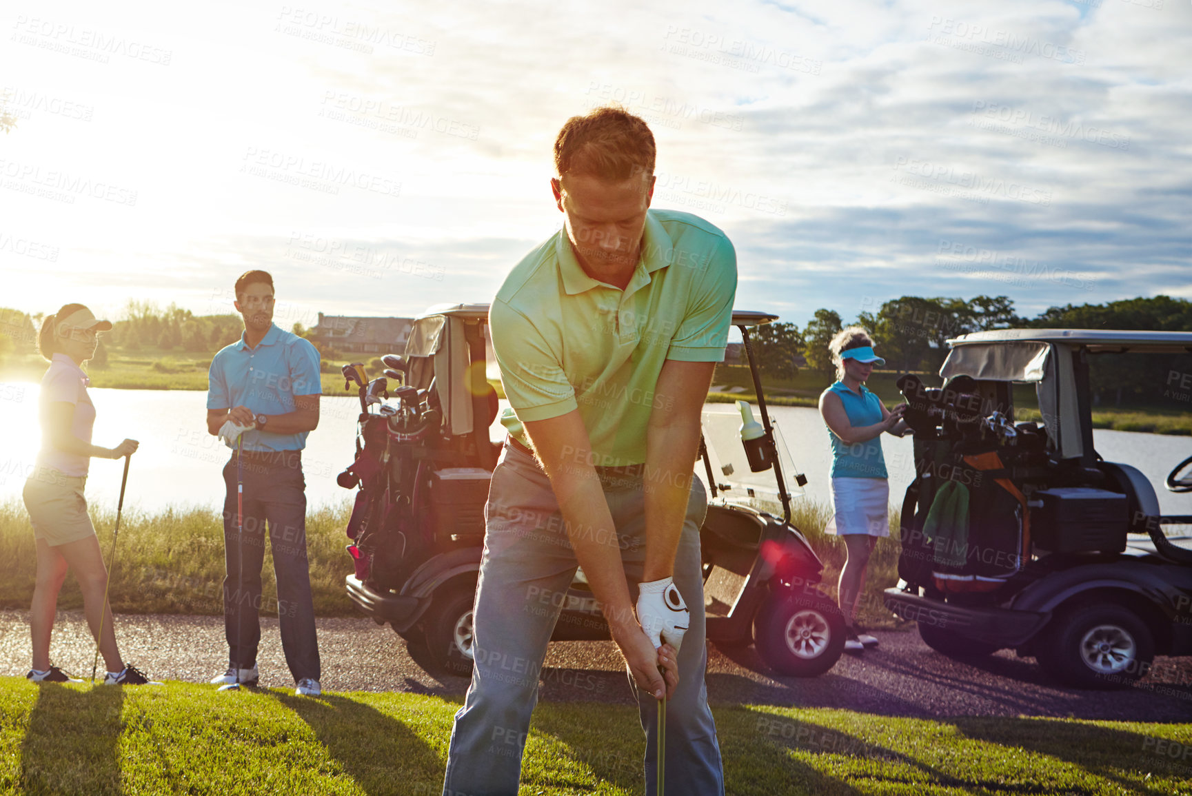 Buy stock photo Shot of a man playing a round of golf with his friends