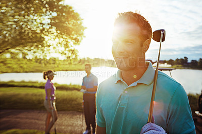 Buy stock photo Shot of a man playing a round of golf with his friends