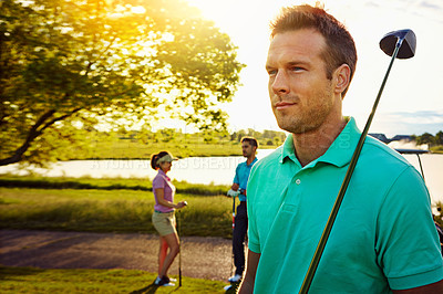 Buy stock photo Shot of a man playing a round of golf with his friends