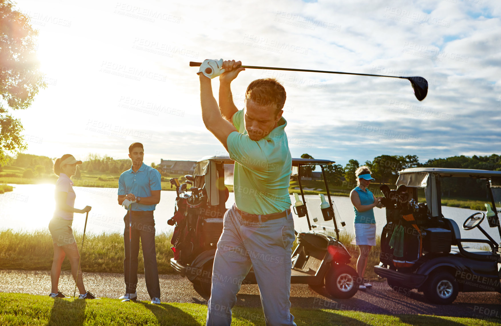 Buy stock photo Sports, swing and man on course with golf challenge, tournament or game in nature at club. Lens flare, cart and male person with group of people for putter outdoor with hobby, training or skill.