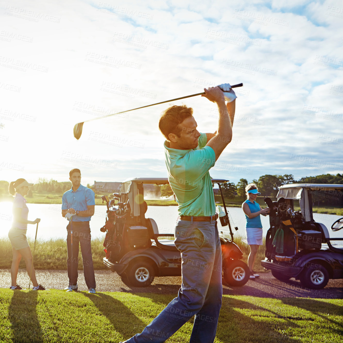 Buy stock photo Shot of a man playing a round of golf with his friends