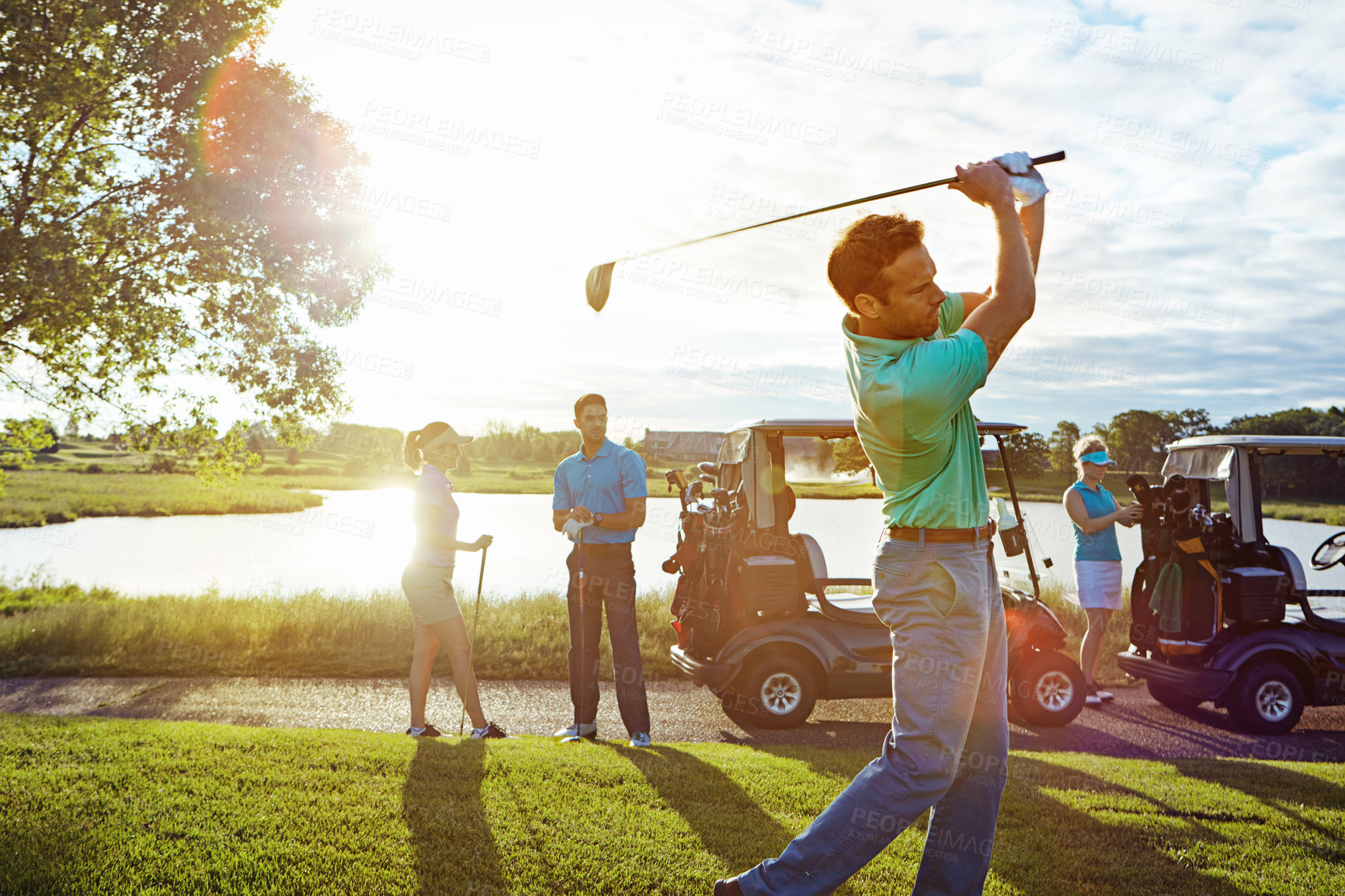 Buy stock photo Shot of a man playing a round of golf with his friends