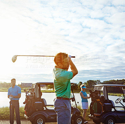Buy stock photo Shot of a man playing a round of golf with his friends