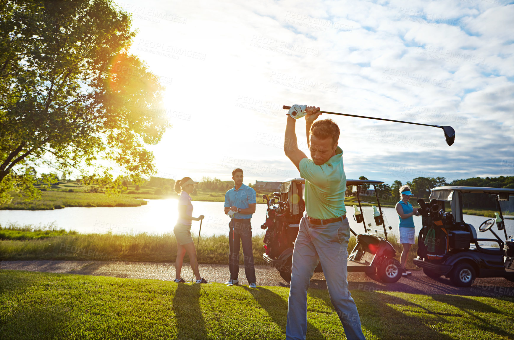 Buy stock photo Shot of a man playing a round of golf with his friends