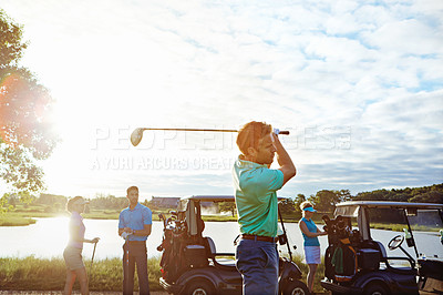 Buy stock photo Shot of a man playing a round of golf with his friends