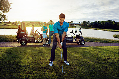 Buy stock photo Shot of a man playing a round of golf with his friends