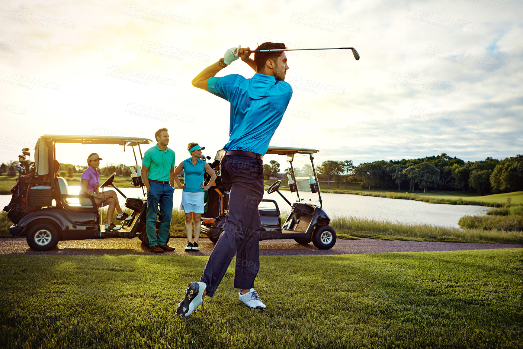 Buy stock photo Shot of a man playing a round of golf with his friends