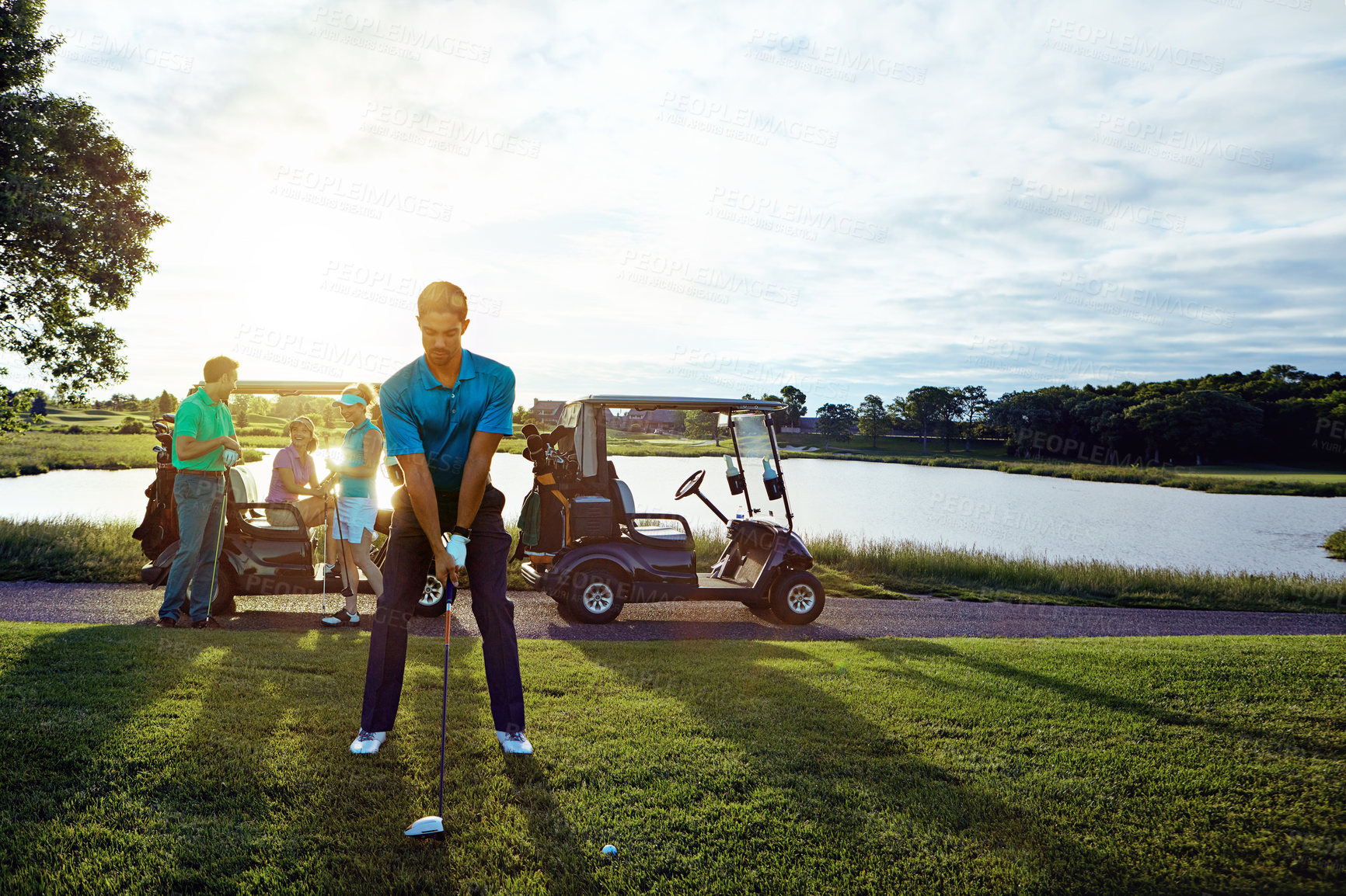 Buy stock photo Shot of a man playing a round of golf with his friends