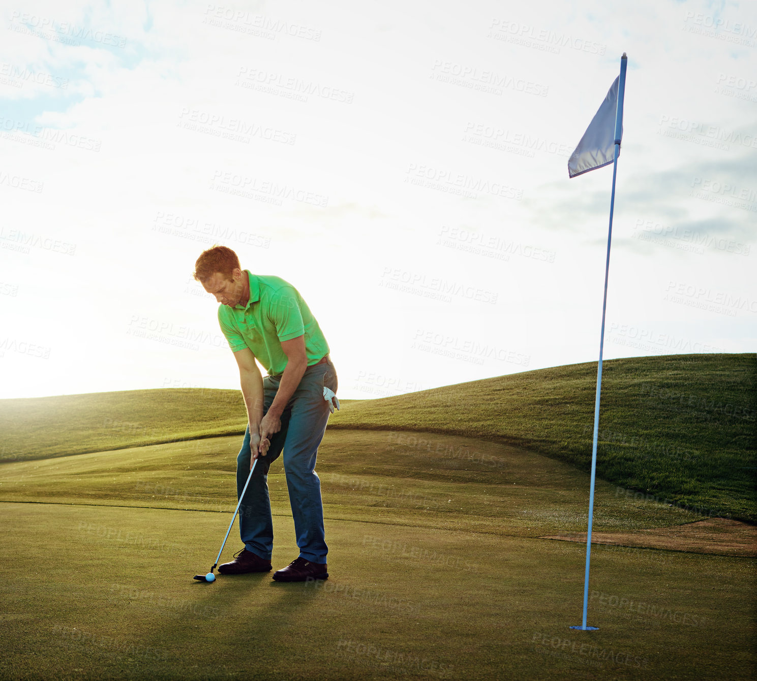 Buy stock photo Shot of a young man spending the day on a golf course