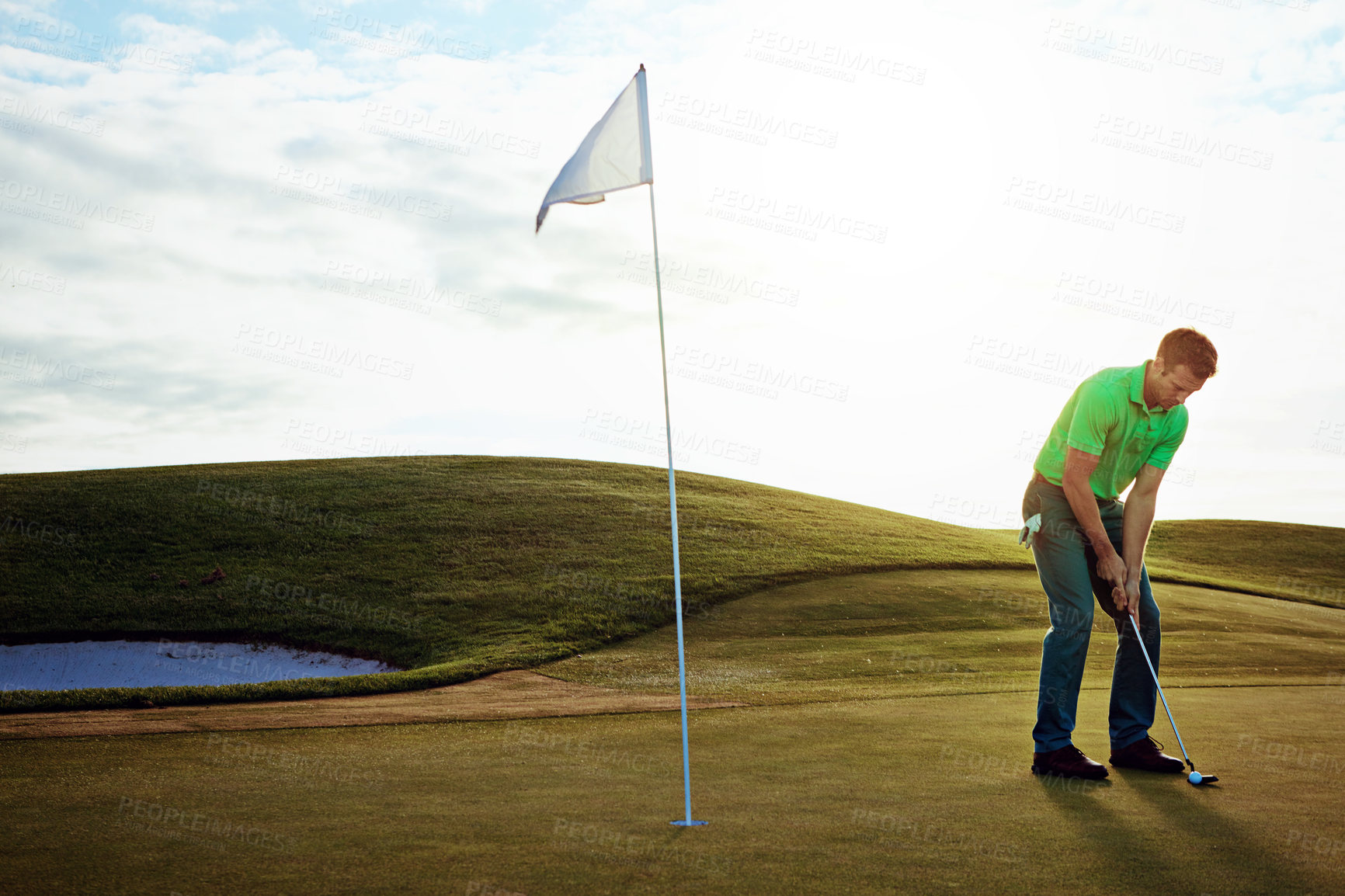 Buy stock photo Shot of a young man spending the day on a golf course