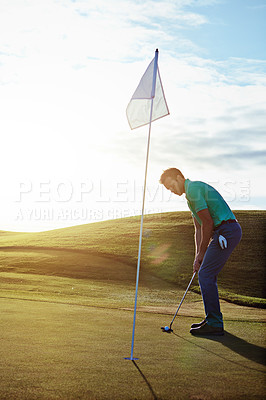 Buy stock photo Shot of a young man spending the day on a golf course