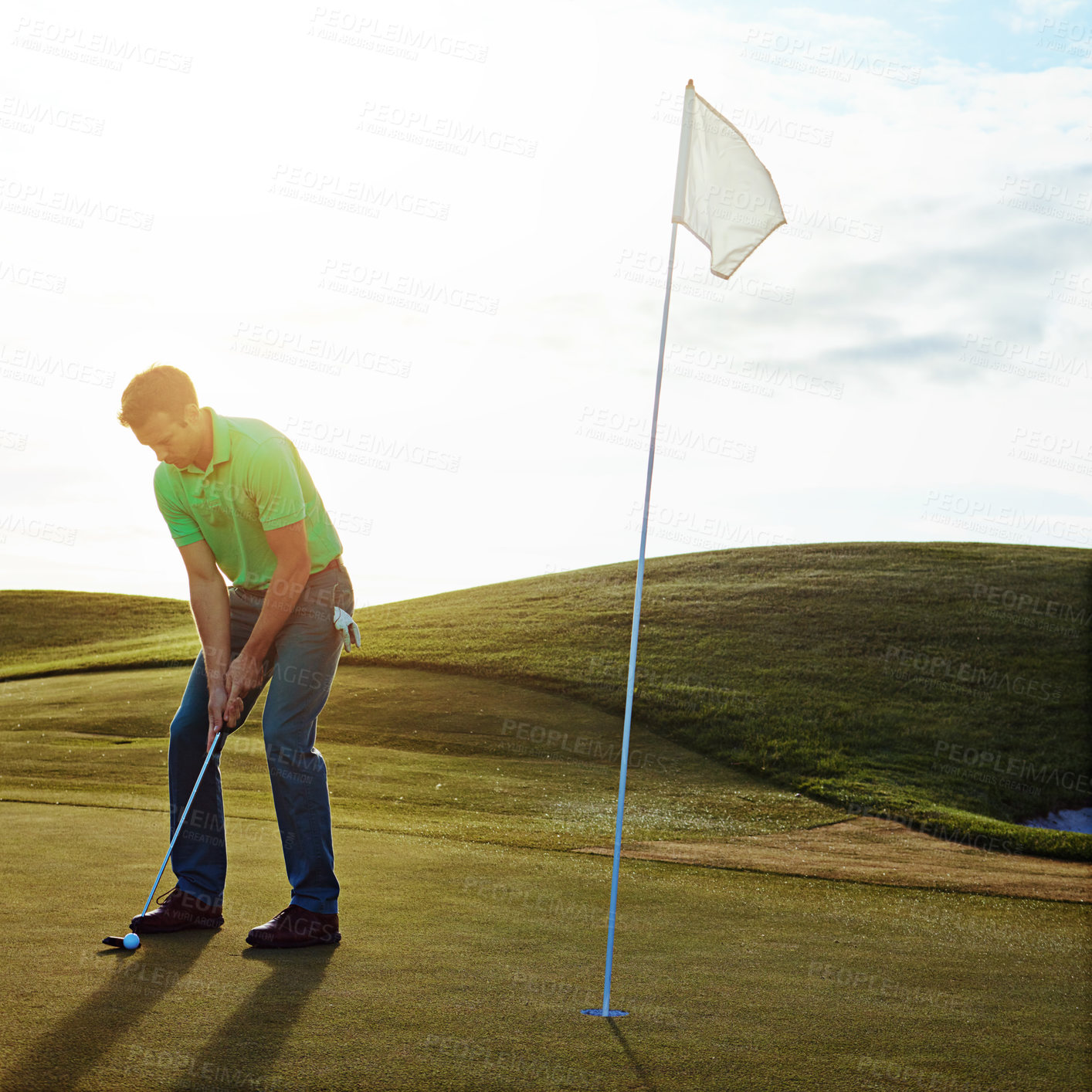 Buy stock photo Shot of a young man spending the day on a golf course