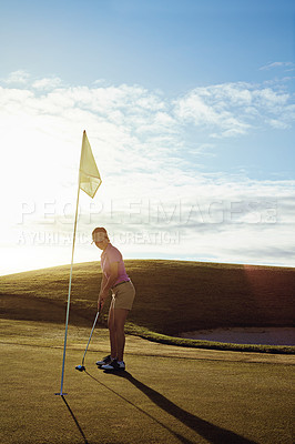 Buy stock photo Shot of a woman playing golf on a sunny day