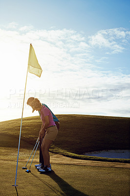 Buy stock photo Shot of a couple playing golf together on a fairway