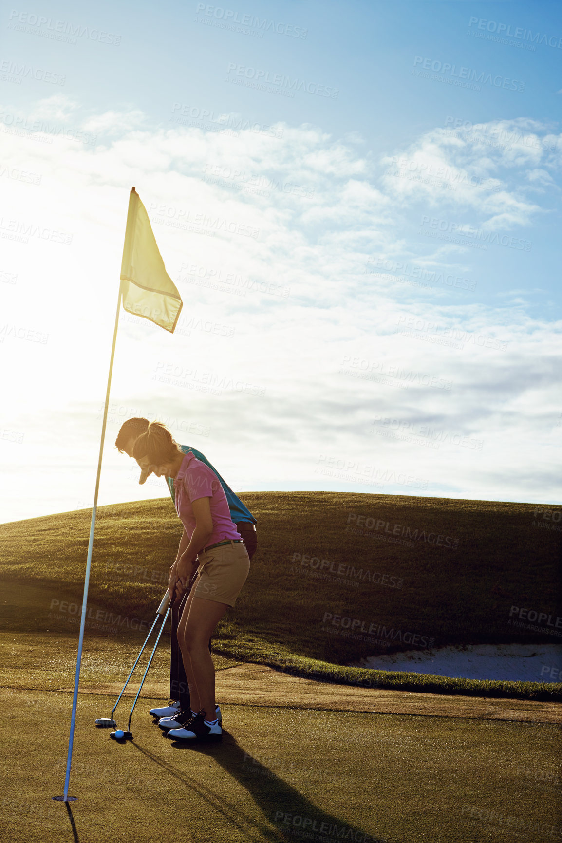 Buy stock photo Shot of a couple playing golf together on a fairway