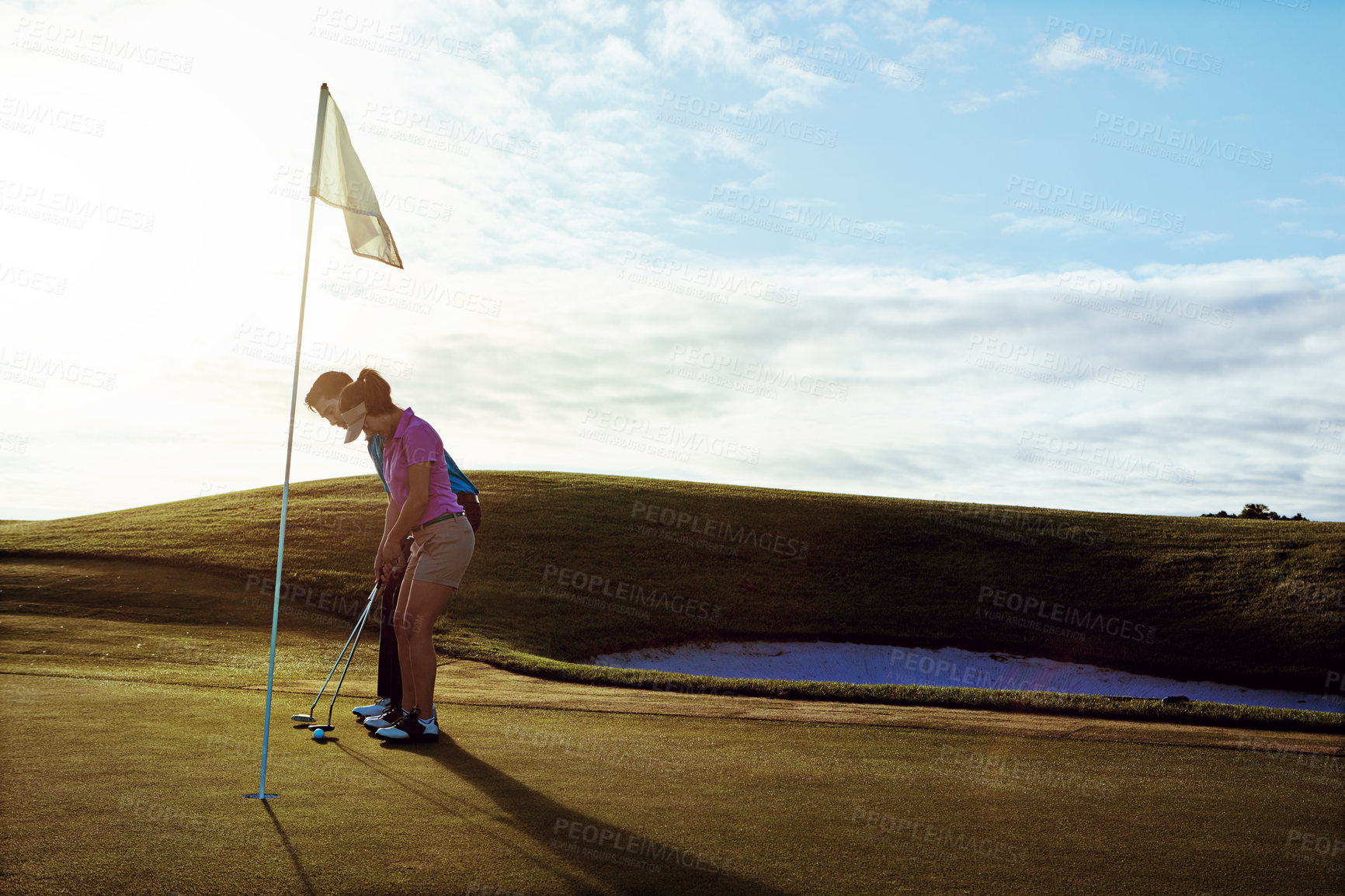 Buy stock photo Shot of a couple playing golf together on a fairway