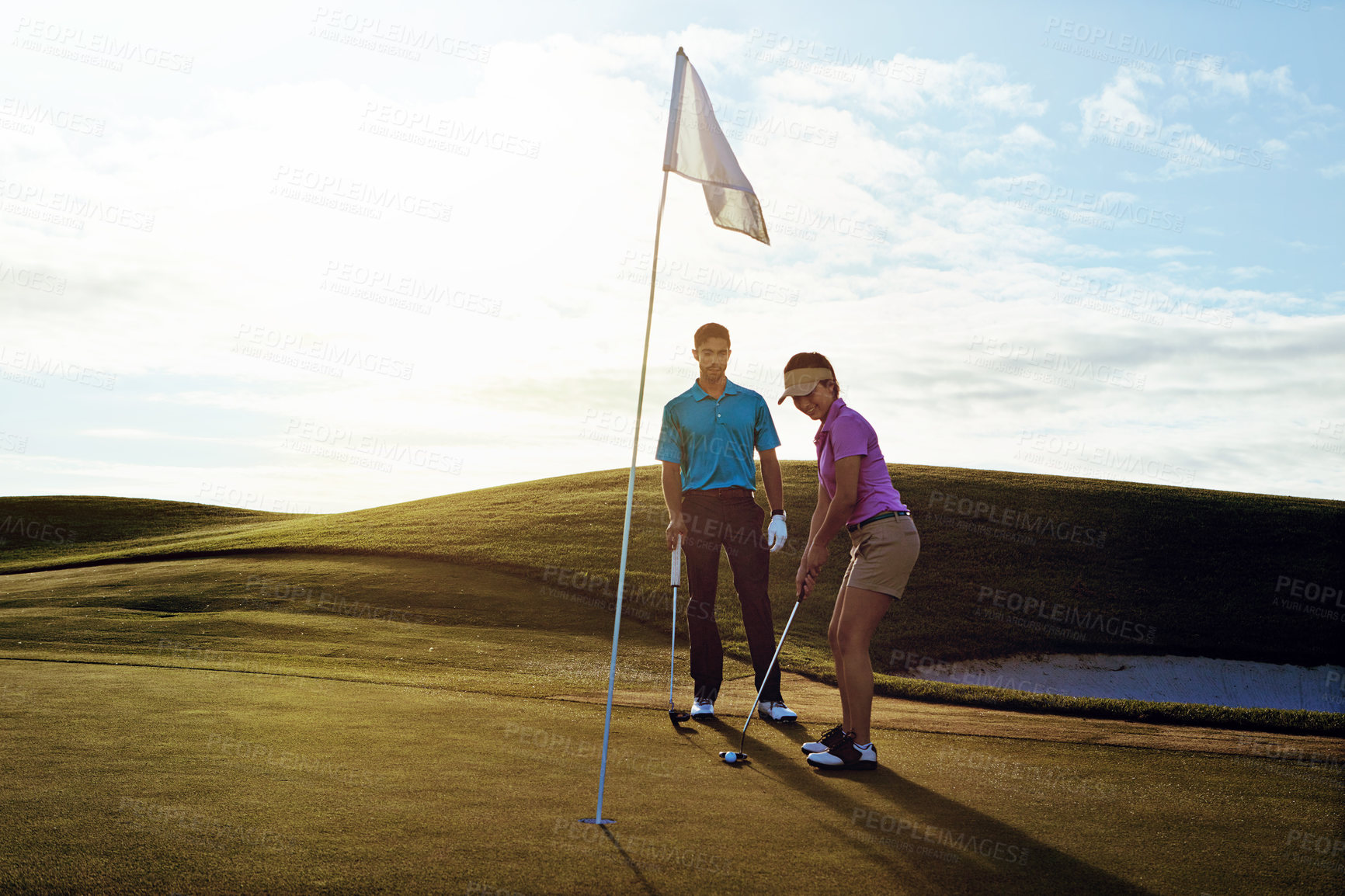 Buy stock photo Shot of a couple playing golf together on a fairway