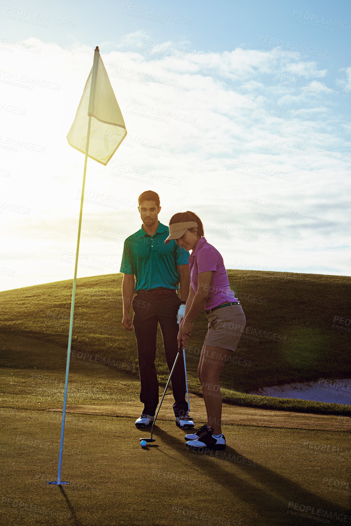 Buy stock photo Shot of a couple playing golf together on a fairway