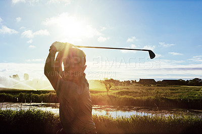 Buy stock photo Shot of a man practicing his swing on the golf course