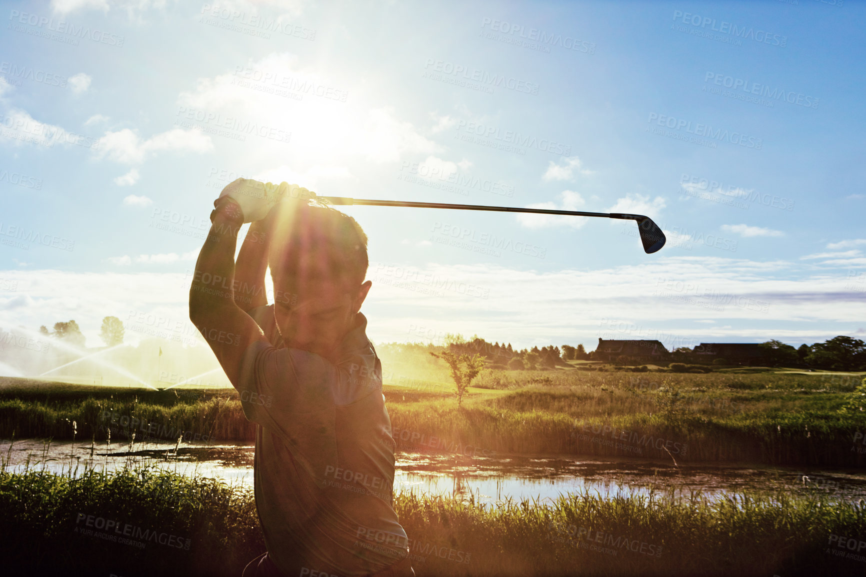 Buy stock photo Shot of a man practicing his swing on the golf course