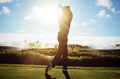 Buy stock photo Shot of a man practicing his swing on the golf course