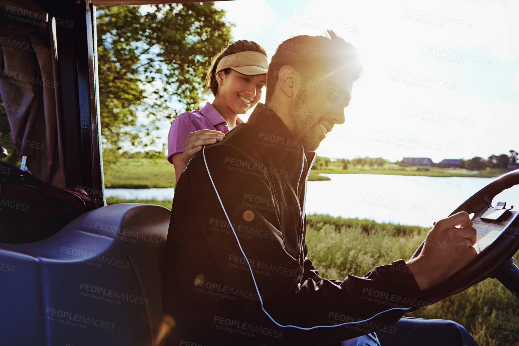 Buy stock photo Shot of a man writing on a score card while out for a game of golf with his wife