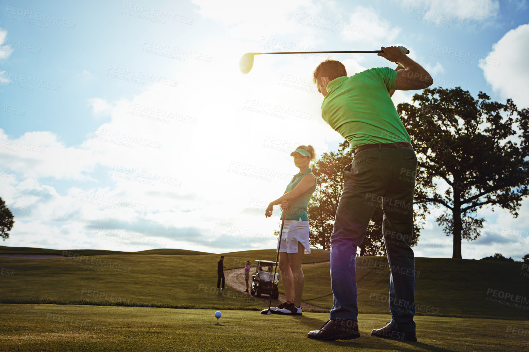 Buy stock photo Shot of a couple playing golf together on a fairway