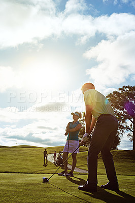 Buy stock photo Shot of a couple playing golf together on a fairway