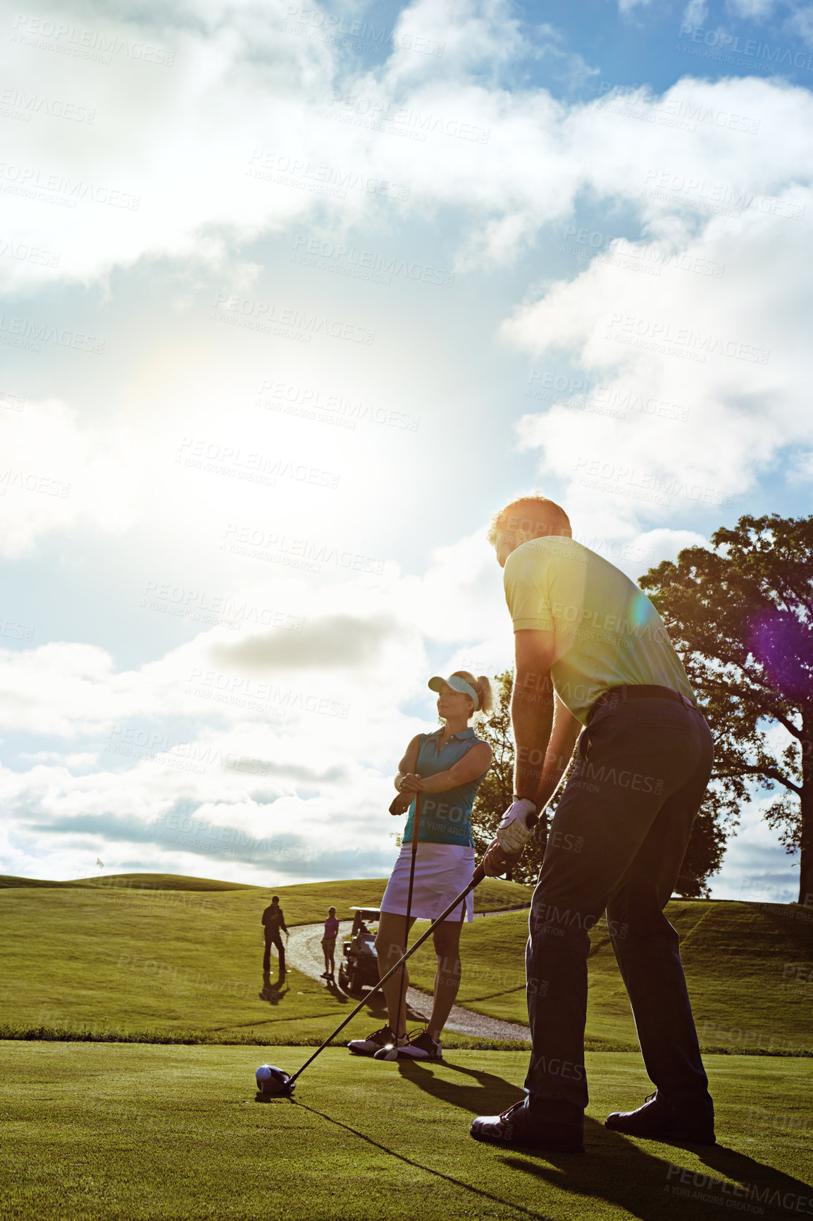 Buy stock photo Shot of a couple playing golf together on a fairway