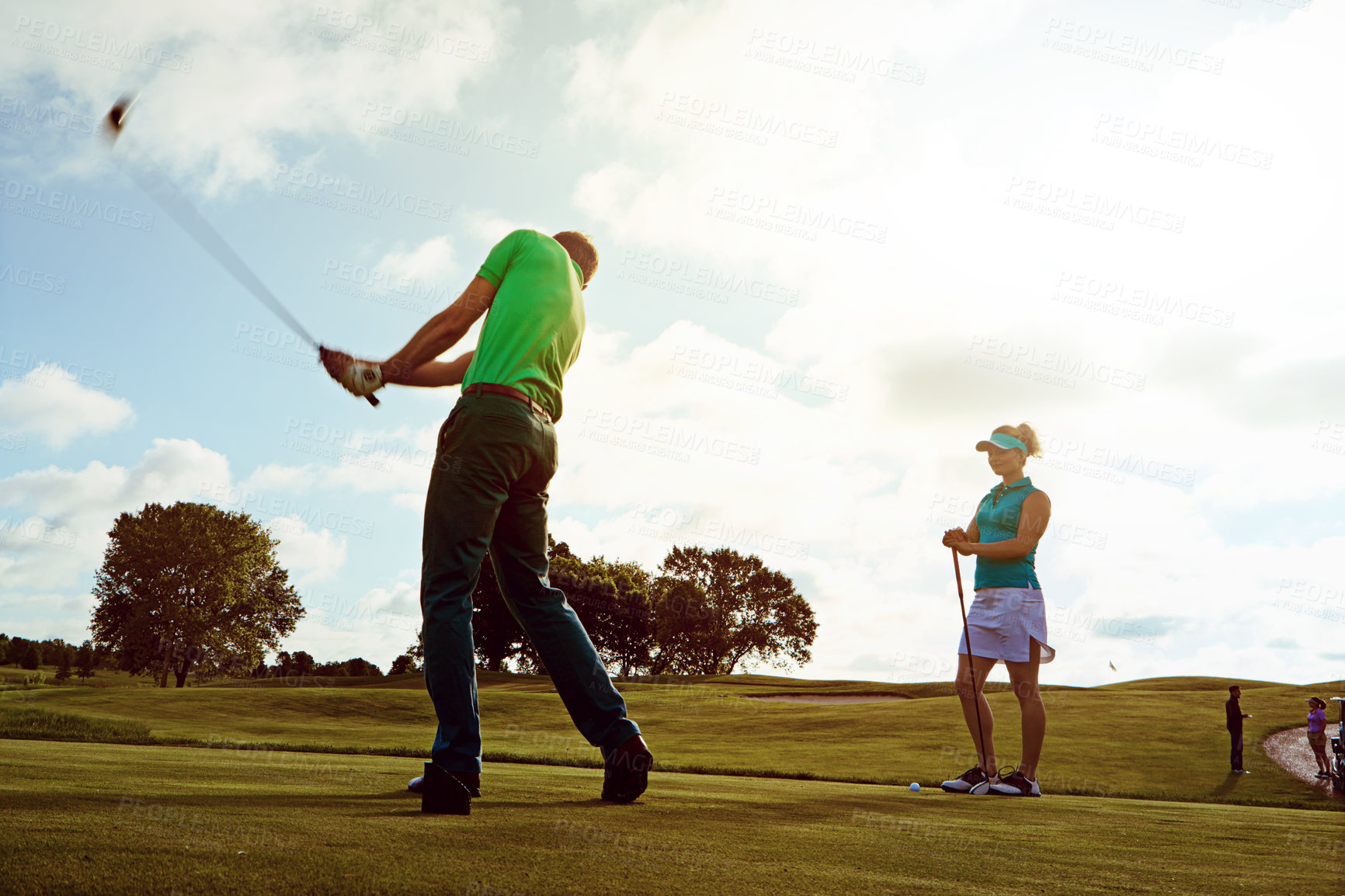 Buy stock photo Sport couple, golf and man with swing on field for competition match, active relationship or hobby. Motion blur, golfer and playing with partner for stroke practice, fitness and bonding on course