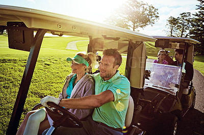 Buy stock photo Shot of a group of friends riding in a golf cart on a golf course