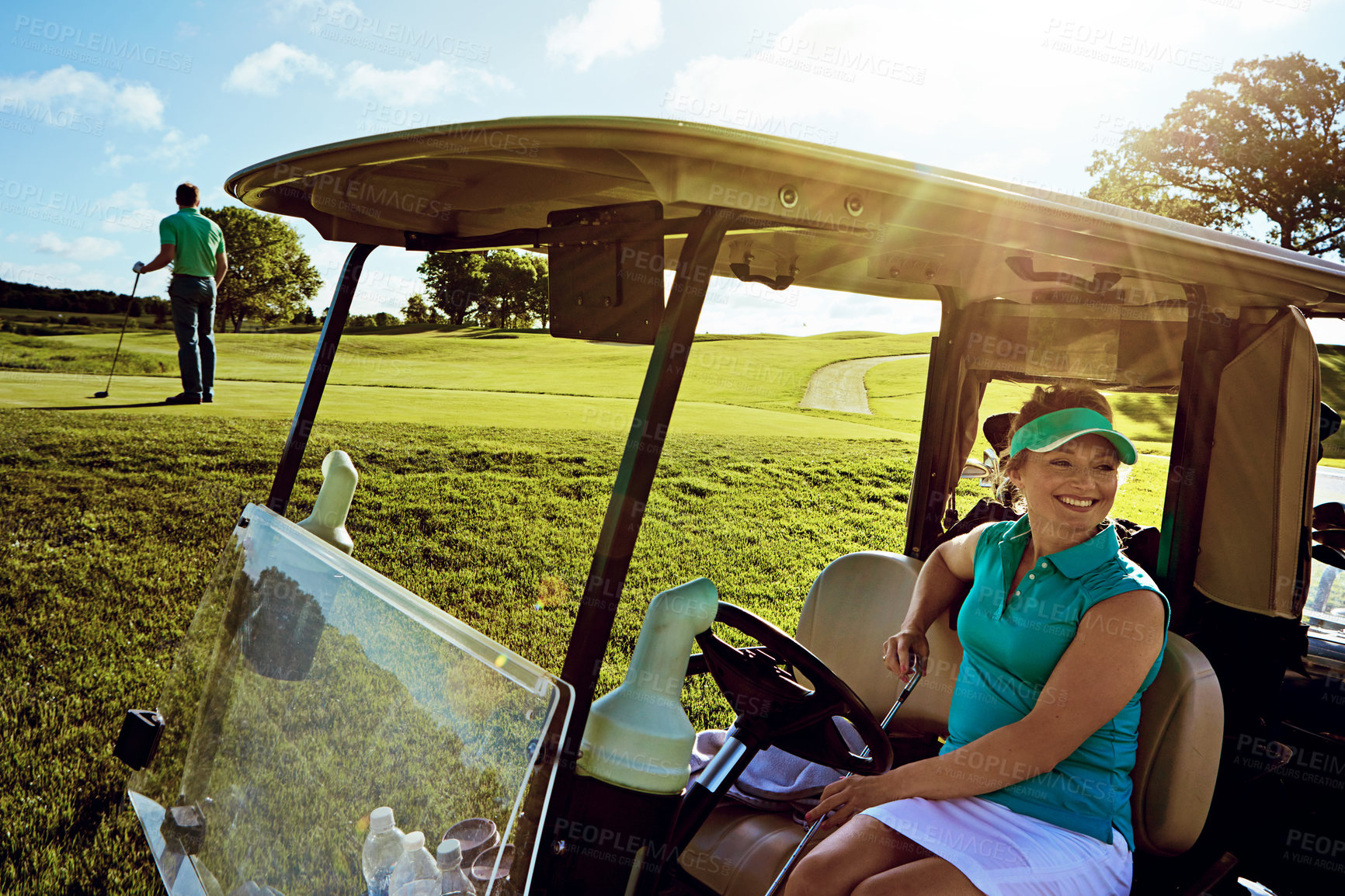 Buy stock photo Shot of woman sitting in a golf cart on the fairway